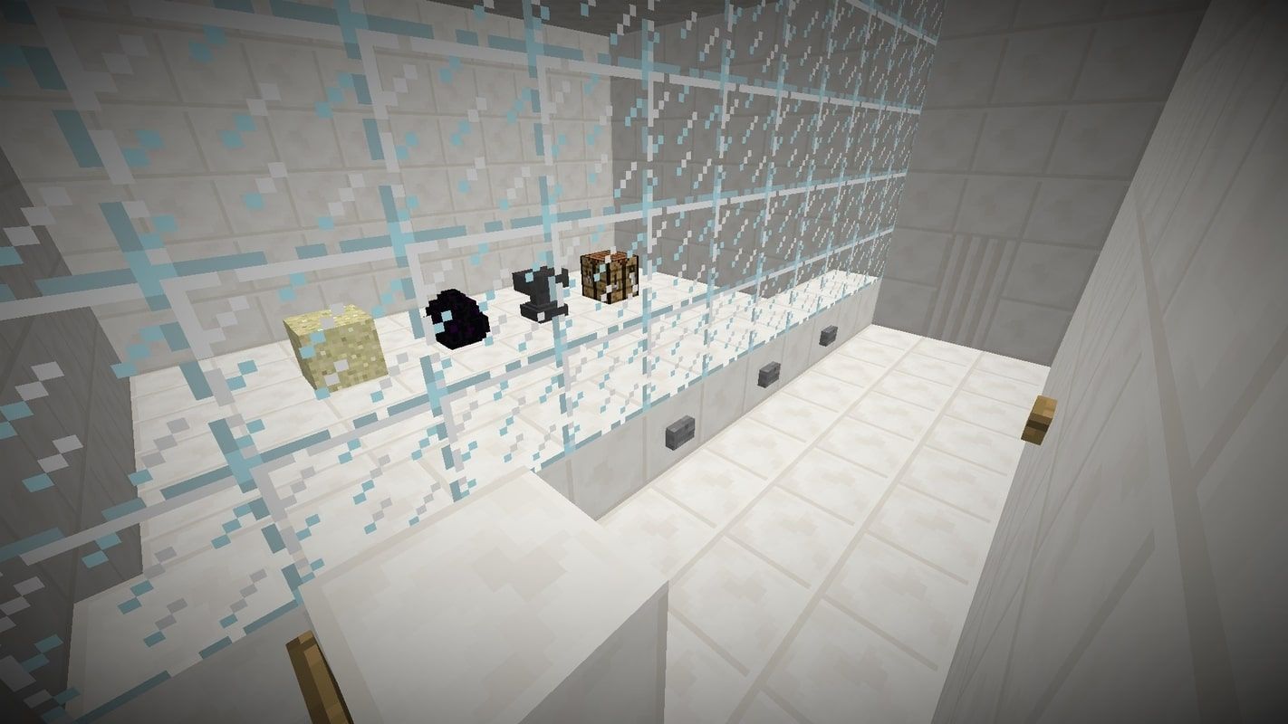 A screenshot from the map showing one of the levels with a block of sand, a dragon egg, an anvil, and a crafting table